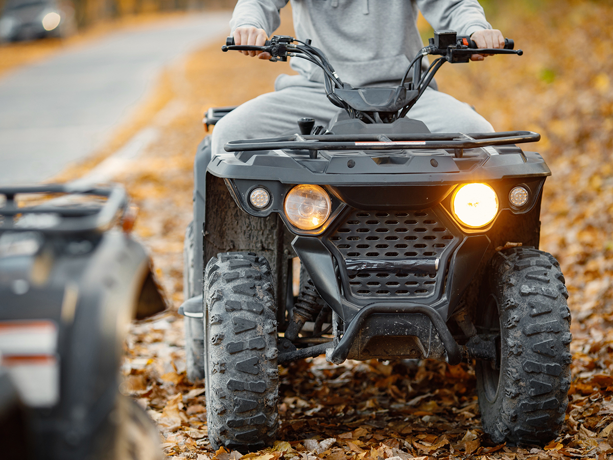 A person sits on a four wheeler.